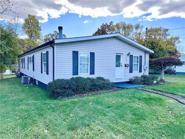 view of front of property with a front lawn and central AC