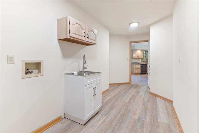 clothes washing area featuring cabinets, hookup for a washing machine, sink, and light wood-type flooring