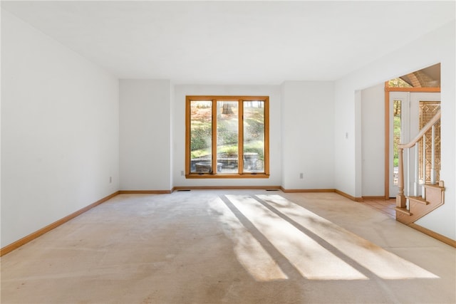 unfurnished room with light colored carpet