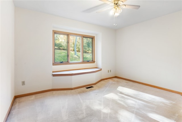 spare room with light carpet and ceiling fan