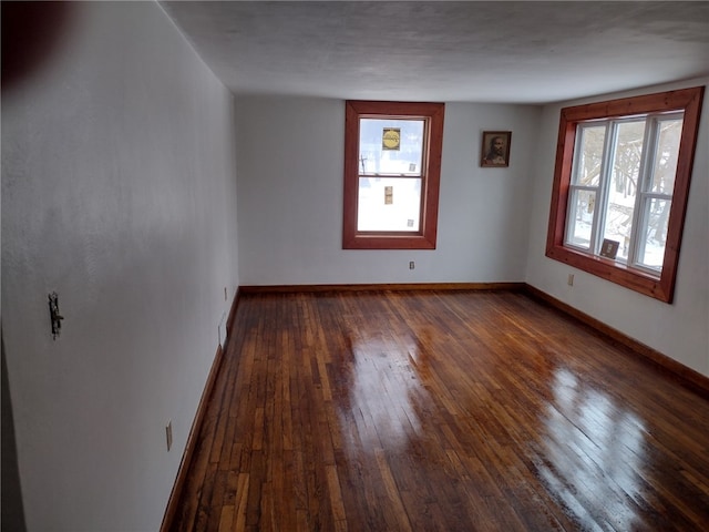 unfurnished room with dark hardwood / wood-style floors