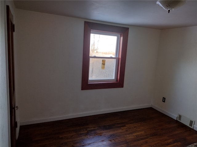 unfurnished room featuring dark hardwood / wood-style floors