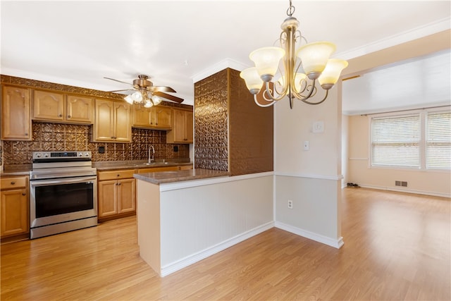 kitchen featuring light hardwood / wood-style floors, backsplash, crown molding, stainless steel stove, and pendant lighting