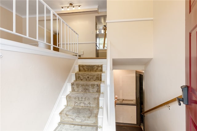 stairs featuring crown molding