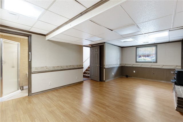 basement with light wood-type flooring and a drop ceiling