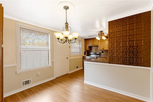 kitchen with ornamental molding, light wood-type flooring, backsplash, hanging light fixtures, and stainless steel electric stove