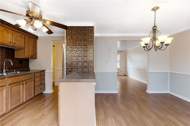 kitchen featuring light hardwood / wood-style floors, sink, and ornamental molding