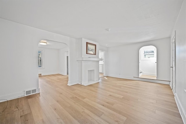 unfurnished living room featuring light hardwood / wood-style floors