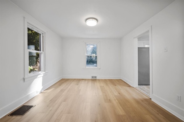 unfurnished room with light wood-type flooring