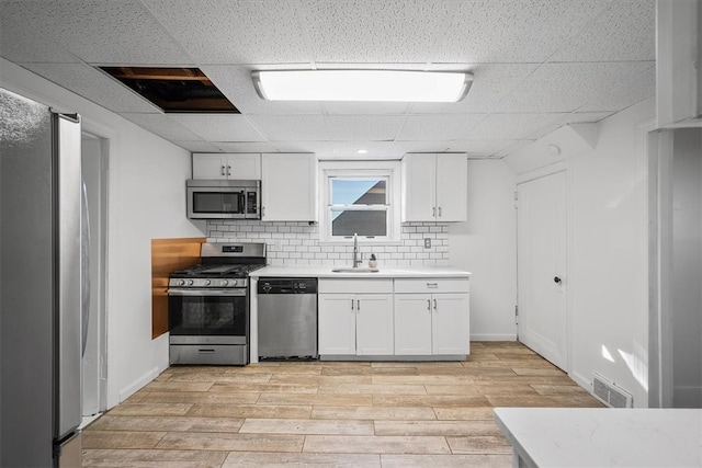 kitchen featuring sink, white cabinetry, stainless steel appliances, and light hardwood / wood-style floors