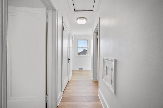 corridor with light wood-type flooring