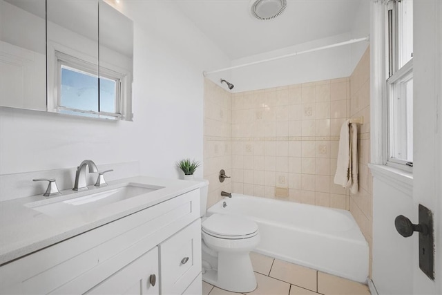 full bathroom with vanity, toilet, tiled shower / bath combo, and tile patterned flooring