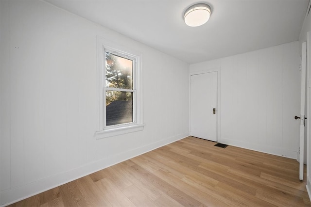 unfurnished room with light wood-type flooring