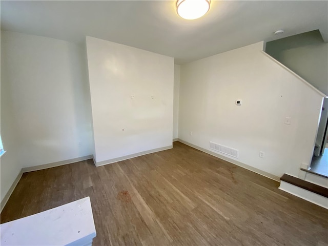 unfurnished room with hardwood / wood-style floors