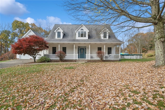 cape cod-style house with a garage and a porch