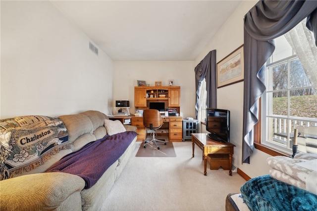 carpeted office space featuring a healthy amount of sunlight