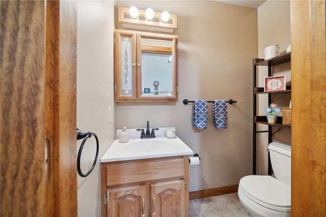 bathroom with vanity, toilet, and tile patterned floors