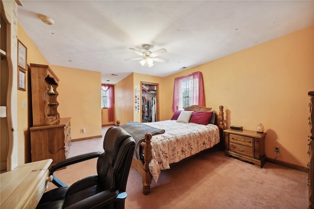 bedroom featuring multiple windows, light colored carpet, and ceiling fan