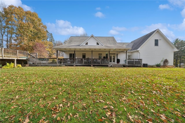 rear view of property featuring a deck and a lawn