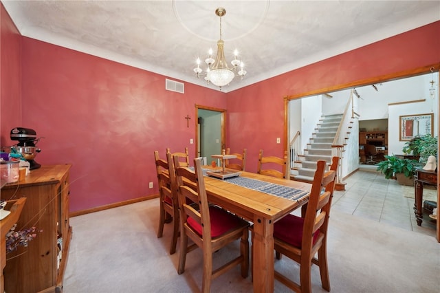 carpeted dining area featuring a chandelier