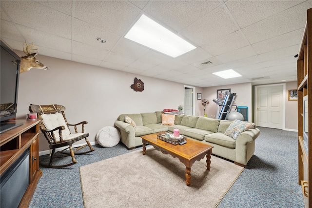 carpeted living room with a paneled ceiling