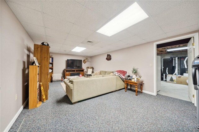 carpeted living room with a paneled ceiling