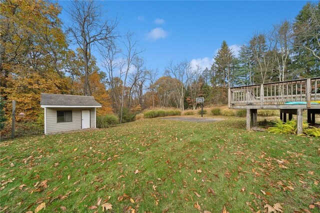 view of yard with a deck and a storage unit