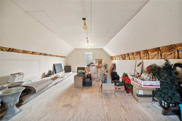 additional living space featuring light hardwood / wood-style flooring and vaulted ceiling