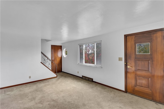 entryway with light colored carpet