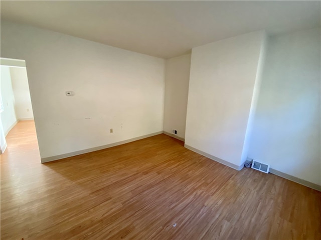 spare room featuring light hardwood / wood-style floors