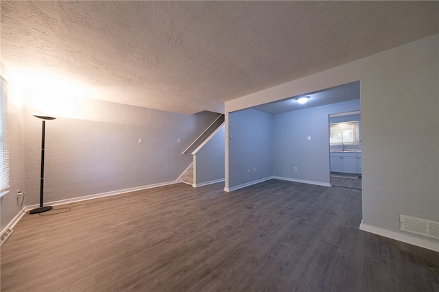 bonus room featuring dark hardwood / wood-style floors and a textured ceiling