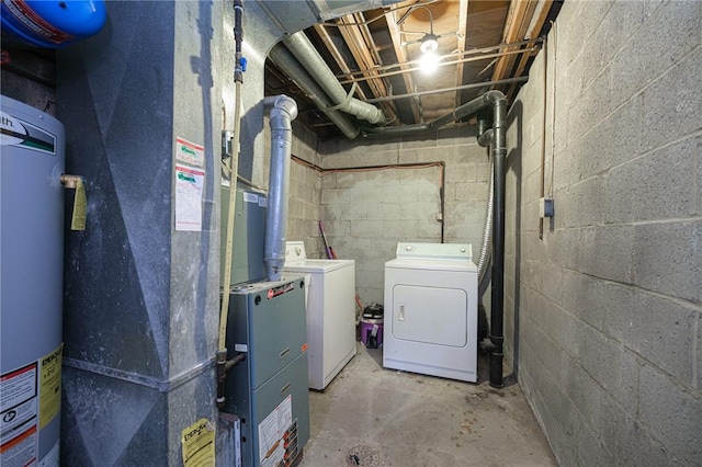 unfinished basement featuring washer and clothes dryer, water heater, and concrete block wall