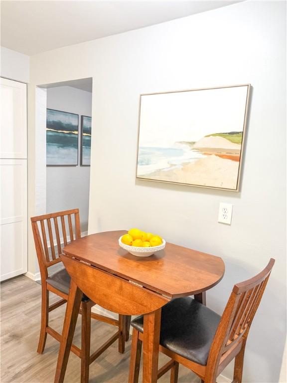 dining space featuring light wood-style floors