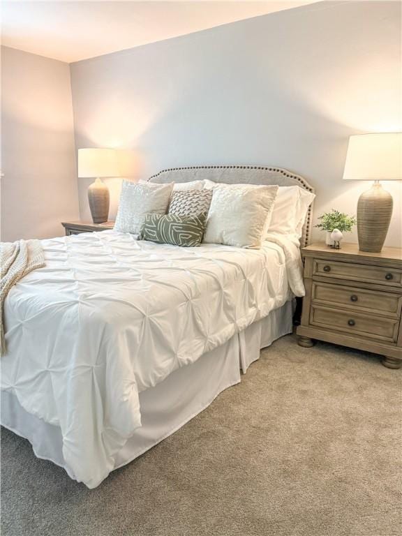 bedroom featuring light carpet