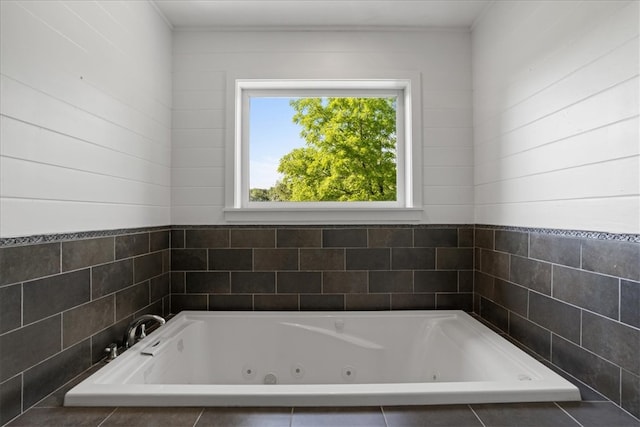 bathroom featuring a relaxing tiled tub