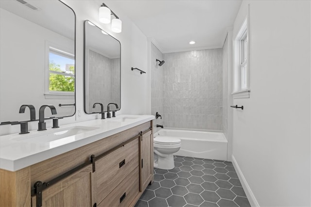 full bathroom featuring toilet, tiled shower / bath, vanity, and tile patterned floors