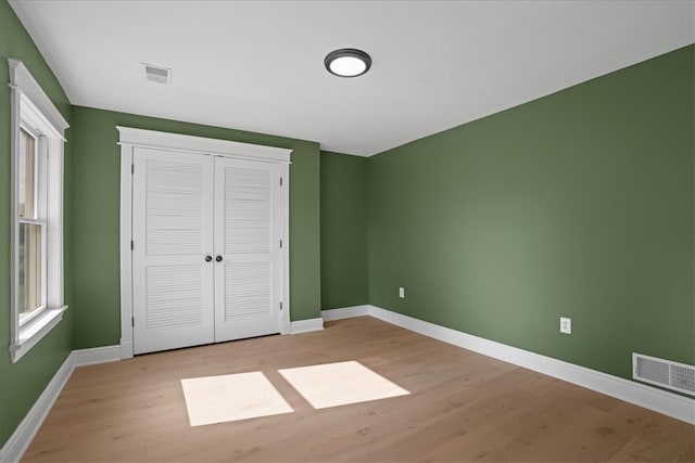 unfurnished bedroom with light wood-type flooring