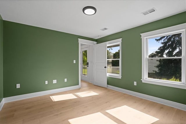 spare room featuring light wood-type flooring