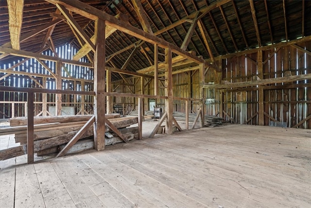 misc room with lofted ceiling and wood-type flooring