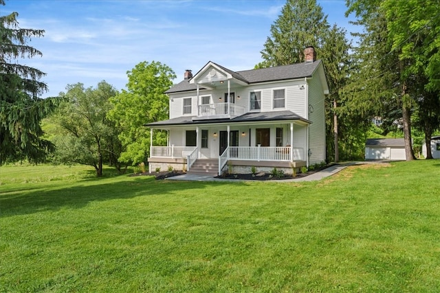 view of front of house with an outdoor structure, a garage, a front lawn, and a porch