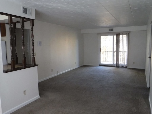 spare room with dark colored carpet