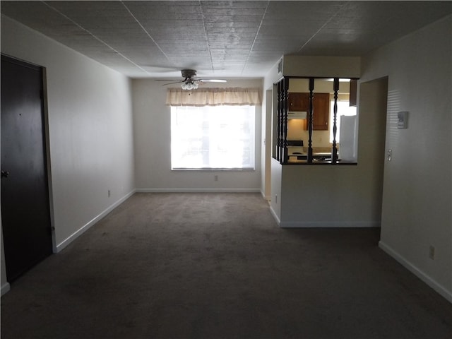 spare room with carpet floors and ceiling fan