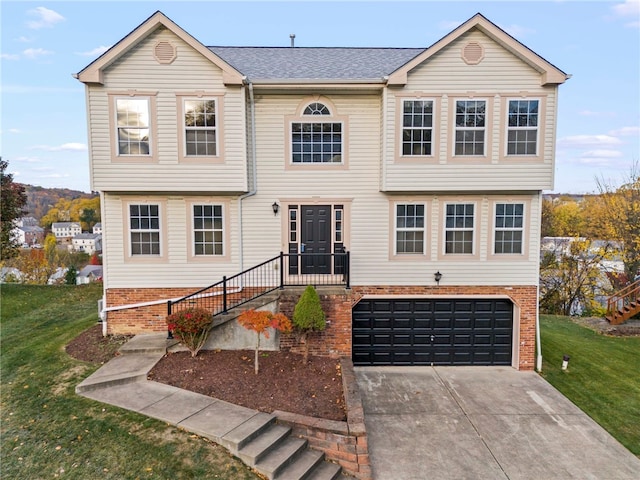 view of front of property with a front lawn and a garage