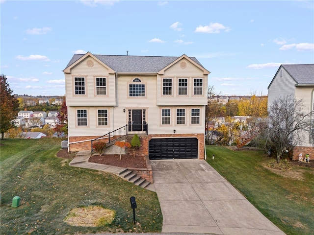 view of front of home featuring a front yard and a garage