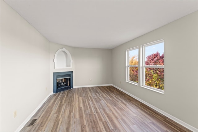 unfurnished living room with light hardwood / wood-style floors