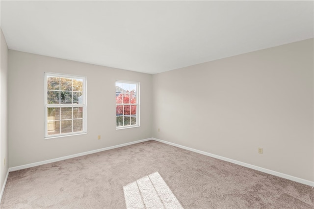 unfurnished room featuring light carpet