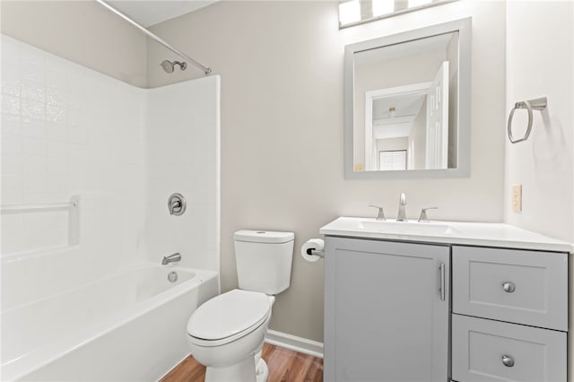 full bathroom with toilet, bathtub / shower combination, vanity, and wood-type flooring