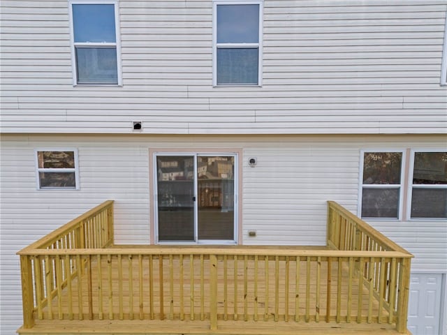 back of house featuring a wooden deck