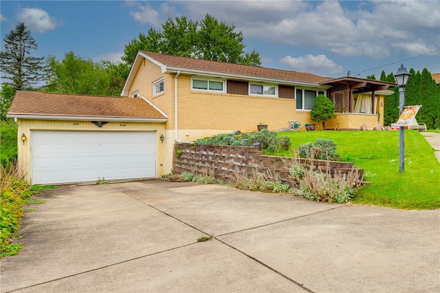 view of front of home with a garage and a front lawn