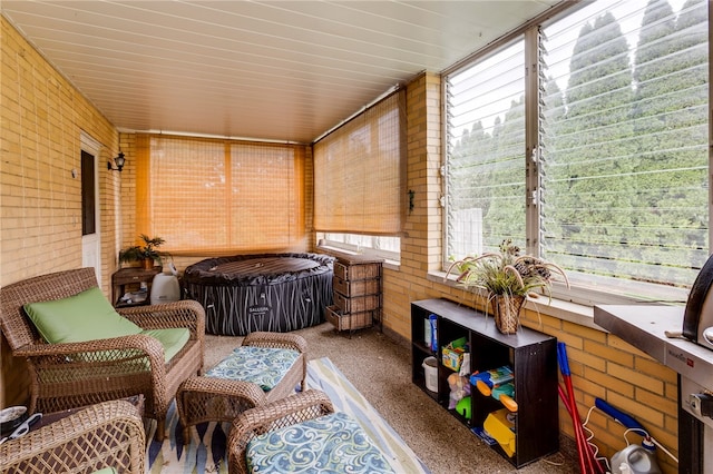 sunroom featuring a hot tub